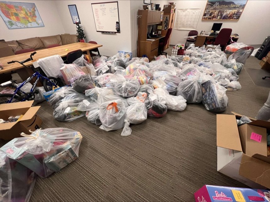 A lot of trash bags laying in a room together. 