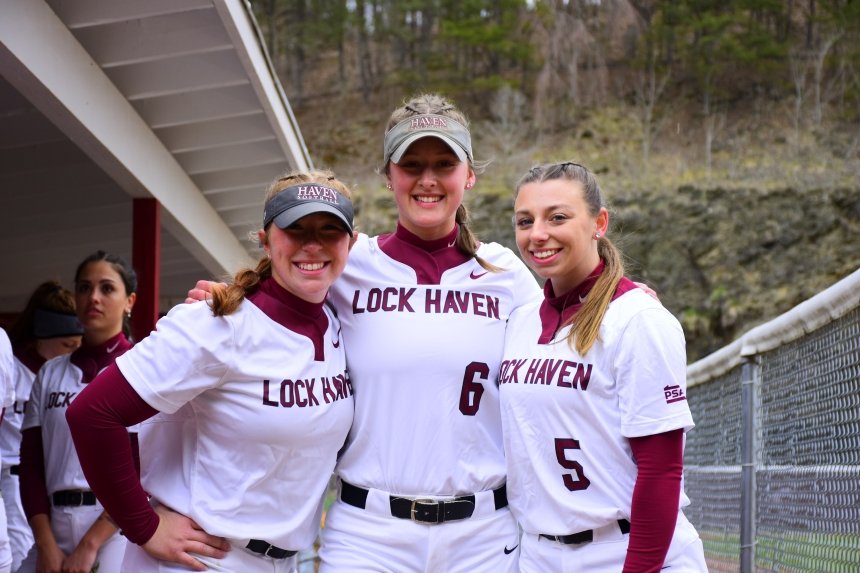 A group of 3 girls standing together in their uniforms. 