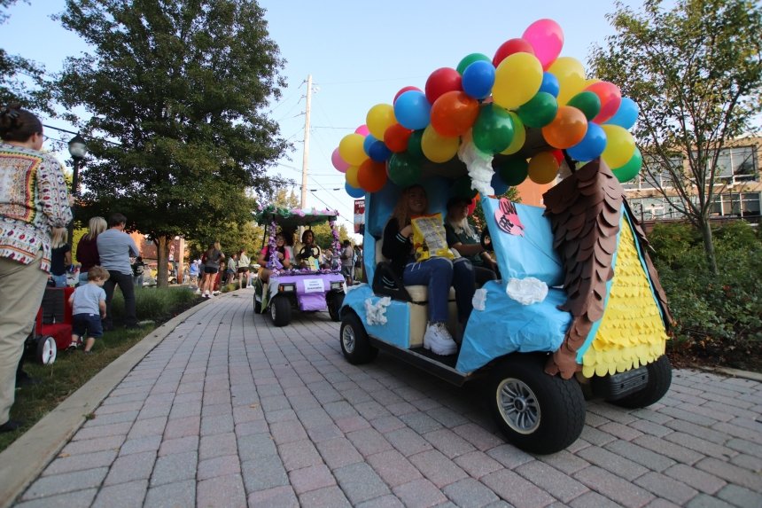 A decorated golf cart driving. 