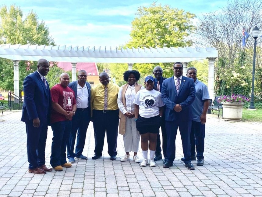 A group of people standing together outside. 