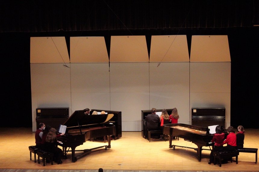 Groups of people playing piano. 