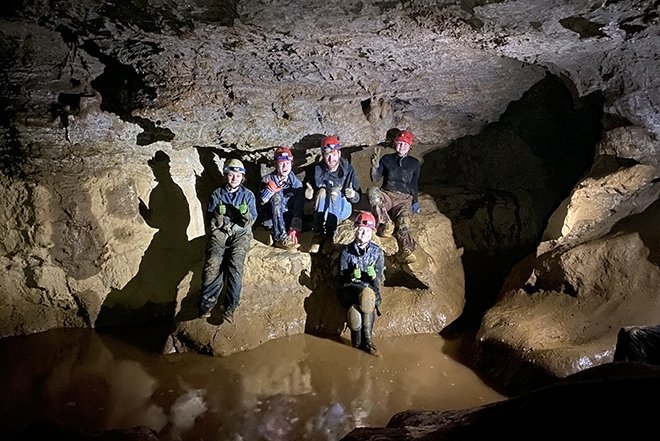 Quest students in a cave.