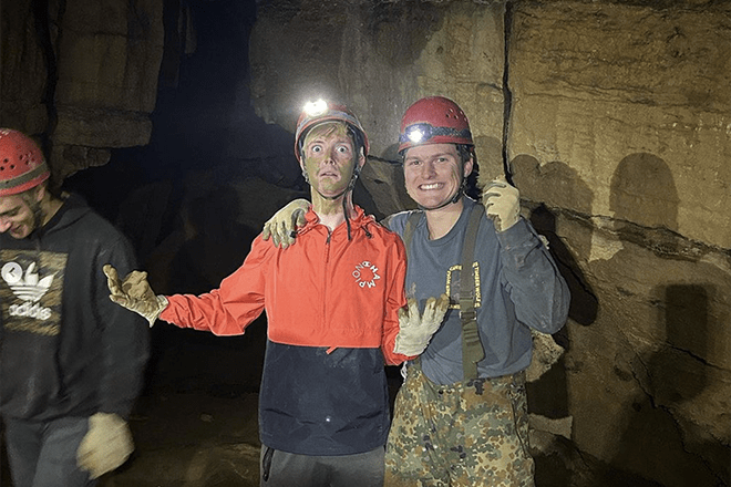 Quest students in a cave.