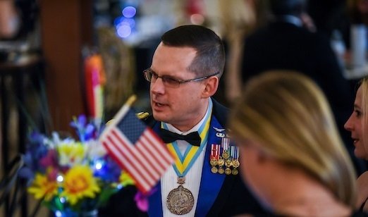 A closeup of a man sitting at a table. 