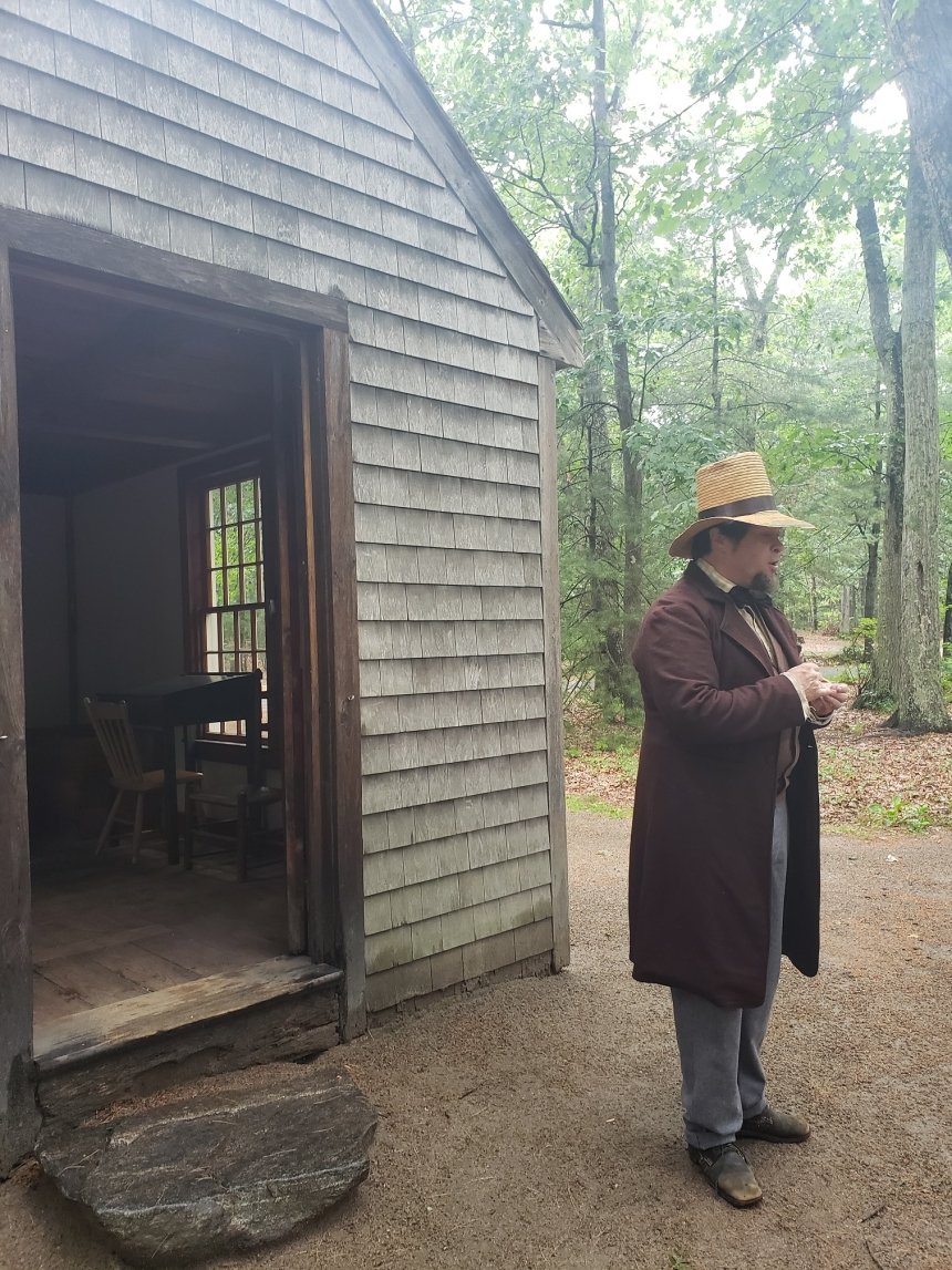 A man dressed up standing outside of an old building. 