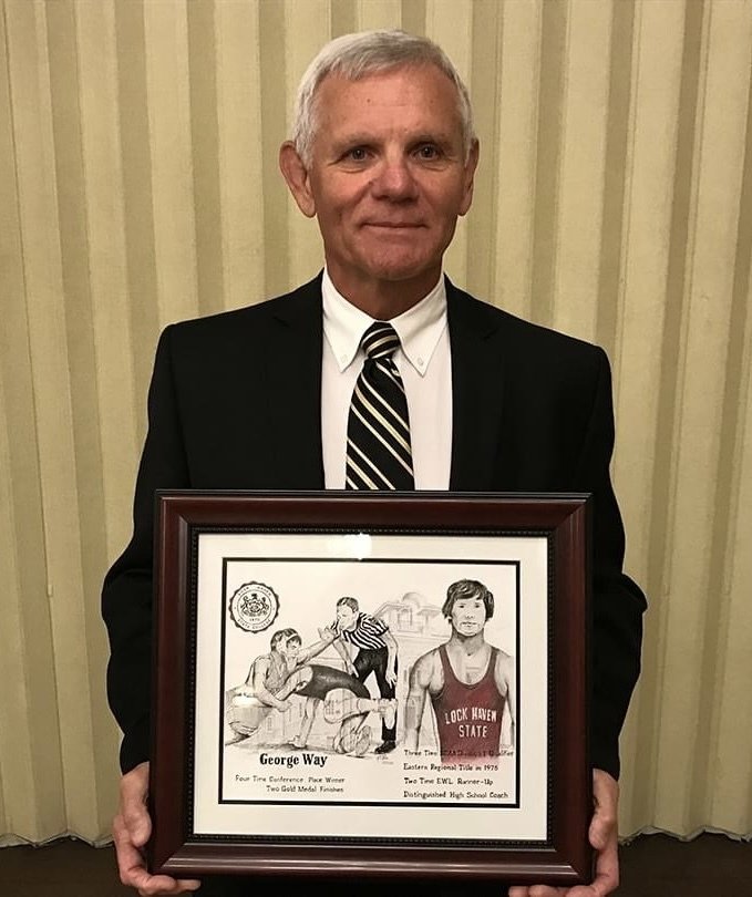 A man holding a picture frame. 