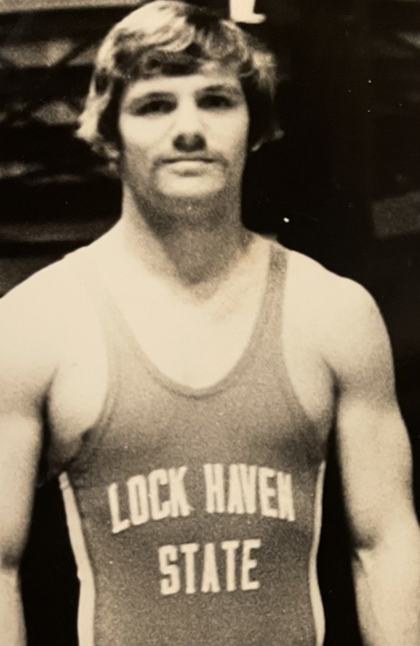 A man in a wrestling uniform. 